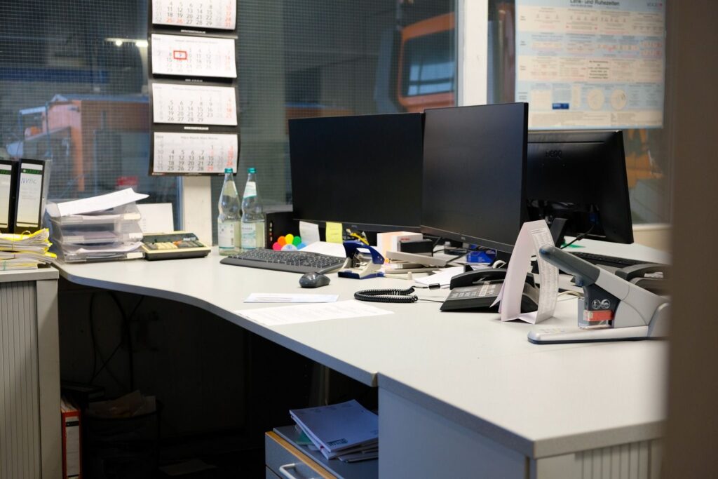 Moderner Bueroarbeitsplatz im Reisebuero mit Computer und Dokumenten.